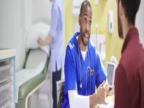 Doctor’s Visits Surgeon in blue and white scrubs, seated